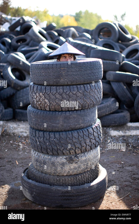 adult-man-with-tires-stacked-around-him-at-the-local-waste-transfer-EWNRT7.thumb.jpg.fda97851f259c278274ca4d64ae4b8a5.jpg
